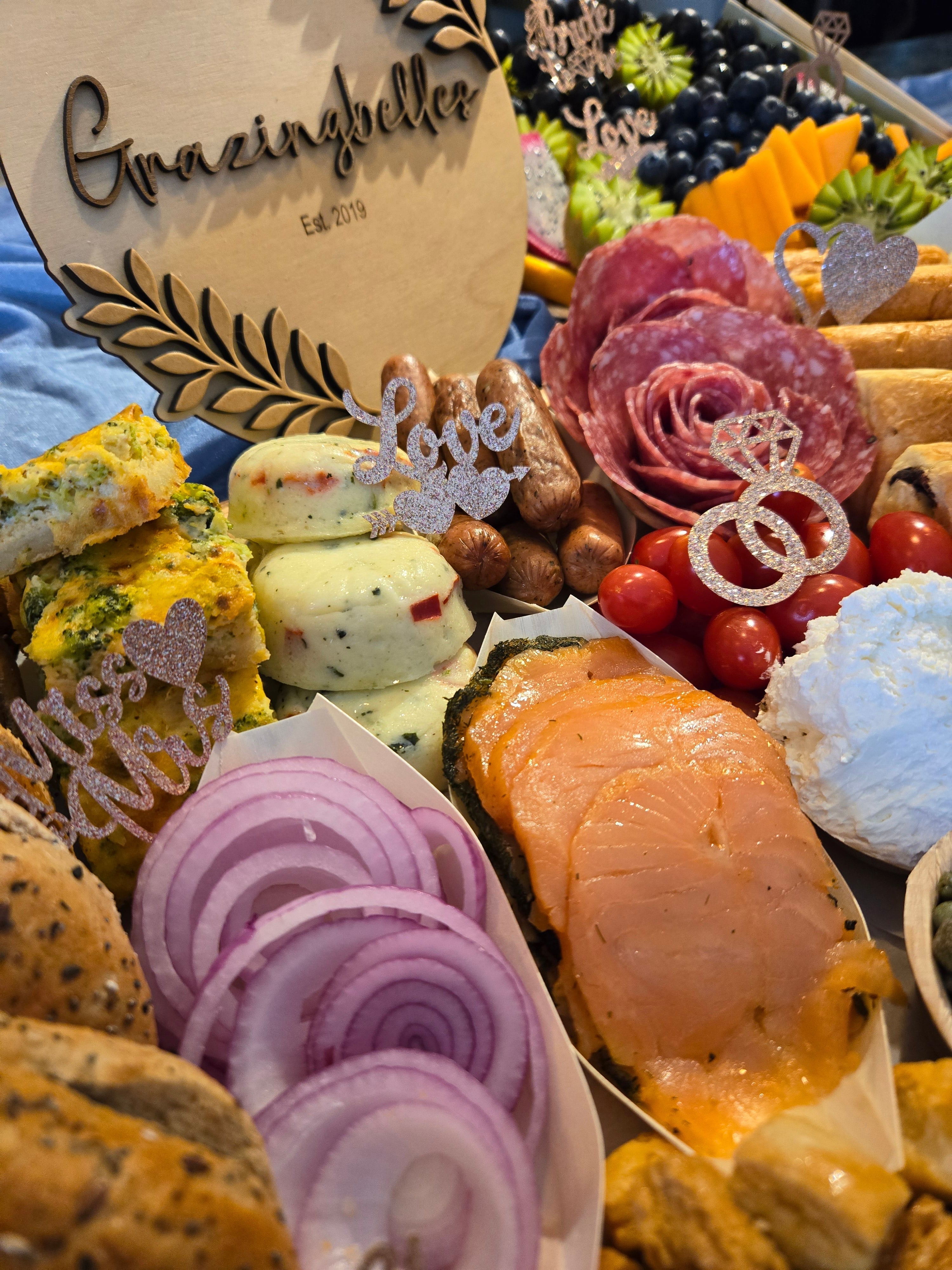 Handcrafted charcuterie board with smoked salmon, salami, red onion, and assorted cheeses.
