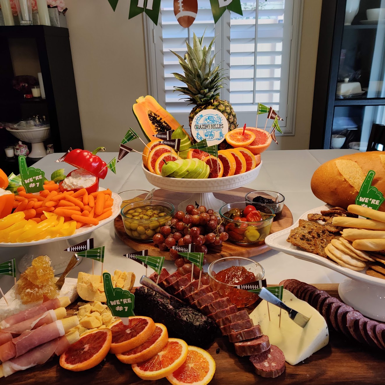 Handcrafted charcuterie board with meats, cheeses, fruits, and olives for catering events.